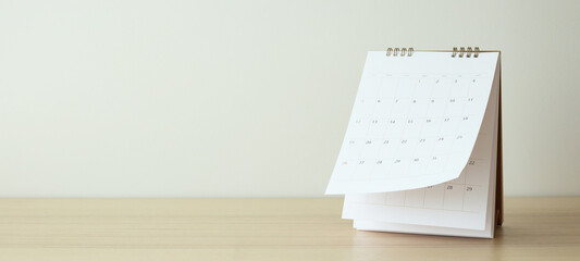 Calendar page flipping sheet on wood table background business schedule planning appointment...