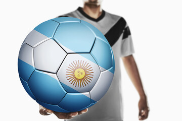 A soccer player holding Argentina soccer ball