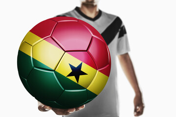 A soccer player holding Ghana soccer ball