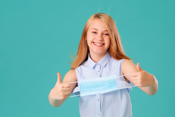 The girl laughs and takes off the mask and smiles, good mood. The concept of quarantine of...