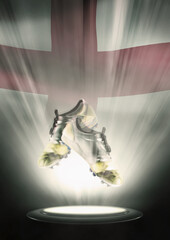 Football cleats with England flag backdrop
