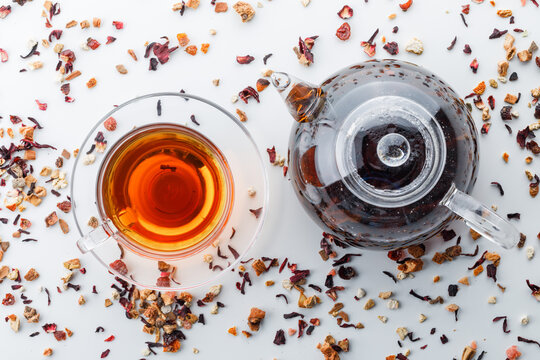 Brewed Tea In Teapot And Cup With Mixed Dried Herbs Top View On A White Background