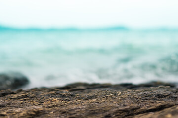 Selective focus od black stone texture for put product to show with beach background.