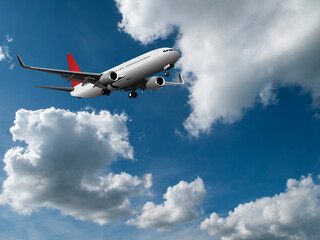 Fototapeta na wymiar Commercial passenger airplane with landing gear down flying across a blue cloudy sky
