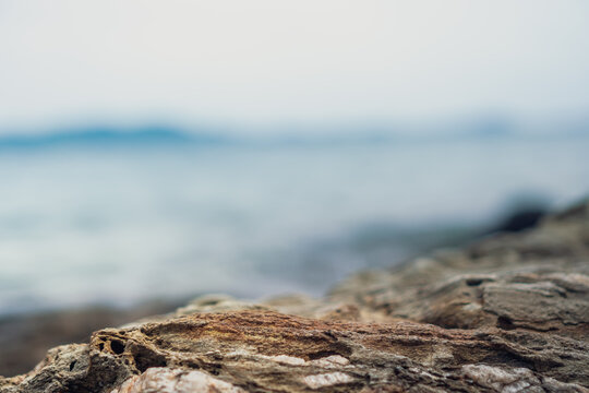 Selective focus od black stone texture for put product to show with beach background.