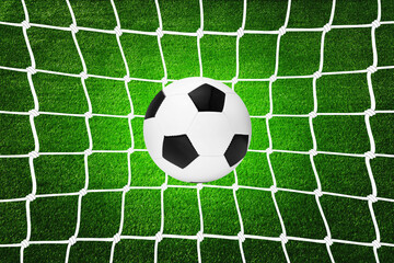 Fototapeta na wymiar A soccer ball in goal net
