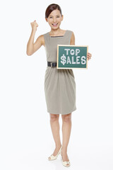 Businesswoman holding up a Top Sales sign