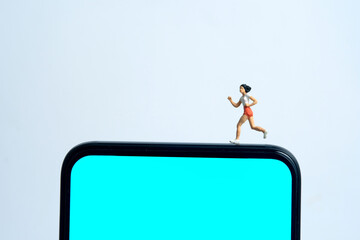 Running and jogging tracking app concept. A men running above smartphone. Miniature people figure...