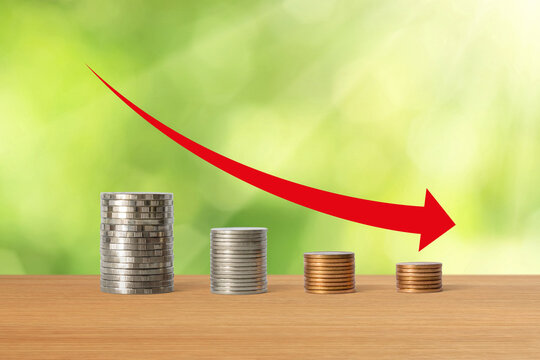 Stacks of coins in a decrease financial concept.