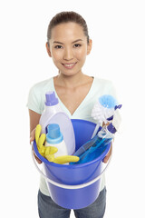 Woman holding a bucket filled with cleaning supplies