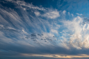 sunset against a background of white clouds in a blue sky
