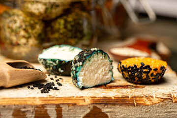 Chevre cheese in aromatic oil with spices in a jar. Farm goat cheese chevre in balls