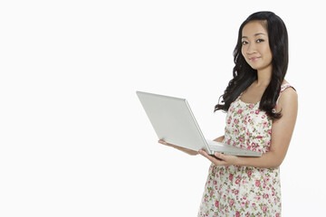 Woman using a laptop while standing