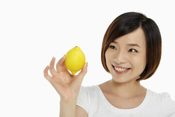 Woman holding up a lemon