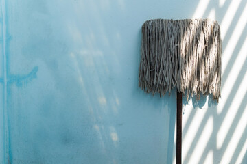 mop on blue wall