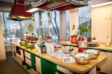 The interior of the kitchen with different kittenware: pots, pans and bottles.