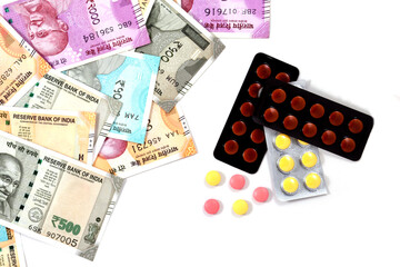 Pile of pharmaceutical drug,  medicine pills and indian money, cost of healthcare and medical insurance concept