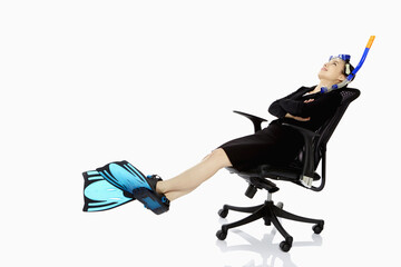 Businesswoman with scuba diving gear resting on a chair