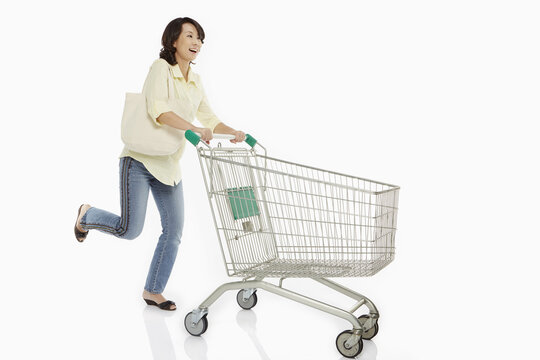 Woman Pushing A Shopping Cart