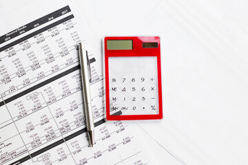 Calculator with pen on finance papers background