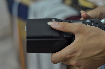man holding a Speedlight (flash) 