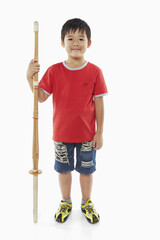 Cheerful boy with a kendo stick