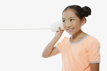 Girl listening to a paper cup phone
