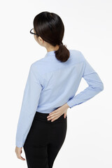 Businesswoman touching her lower back