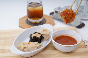 Steamed dumplings Dim Sum and ice tea on white background 