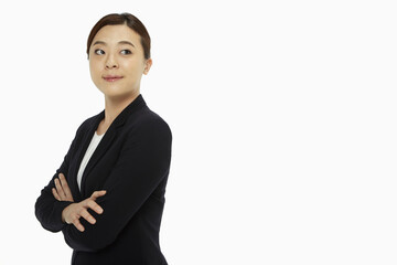 Businesswoman standing with arms crossed, smiling