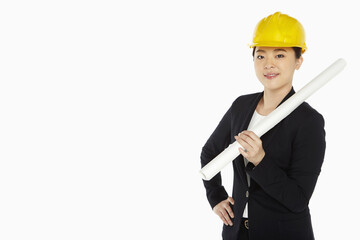 Female architect holding up a construction plan