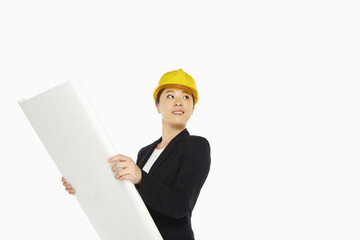 Female architect holding up a construction plan