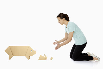 Woman with an assortment of paper animals
