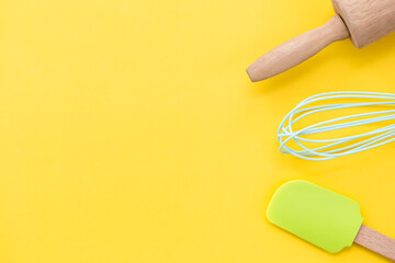 top view baking utensils on yellow background with copy space
