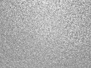 Defocusing. Silver textured shiny background with glitter. Holidays and birthdays. Space for text.