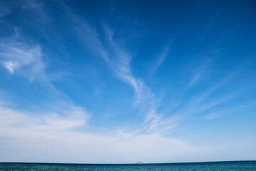 Naklejka na ściany i meble blue sky and clouds on the sea