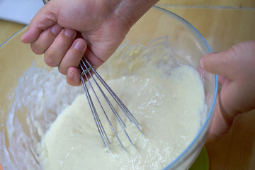 Cooking dough. Stir the dough with a whisk. Stirring whisk dough.