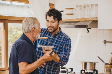 Elder care from young man to stay home and cooking together with family activity in holiday