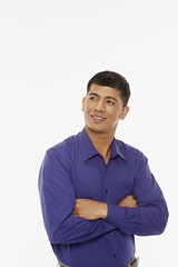 Man standing with arms crossed, smiling