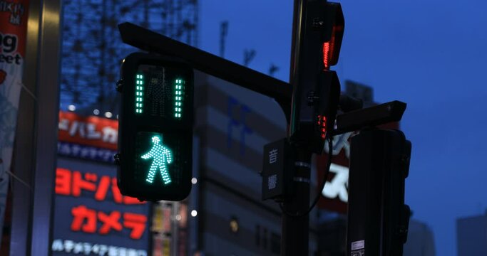 A traffic blue light at the neon town in Shinjuku at night