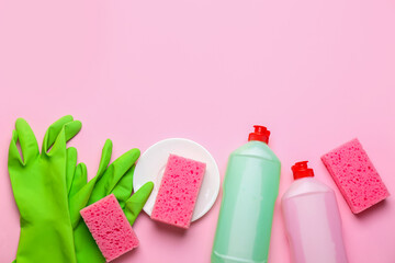 Clean dish, sponges, rubber gloves and detergent on color background