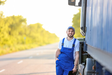 Male driver near big truck outdoors
