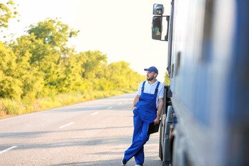 Male driver near big truck outdoors