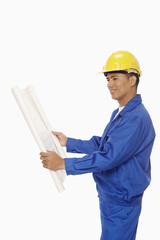Construction worker looking at a blueprint plan