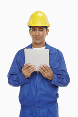 Construction worker using a digital tablet