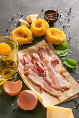 Ingredients for tasty pasta carbonara on dark background