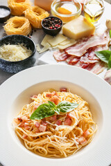 Plate with tasty pasta carbonara on table, closeup