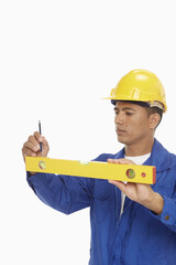 Construction worker measuring with a spirit level
