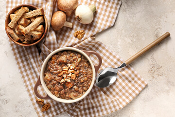 Pot of tasty lentils soup on table