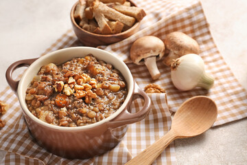 Pot of tasty lentils soup on table